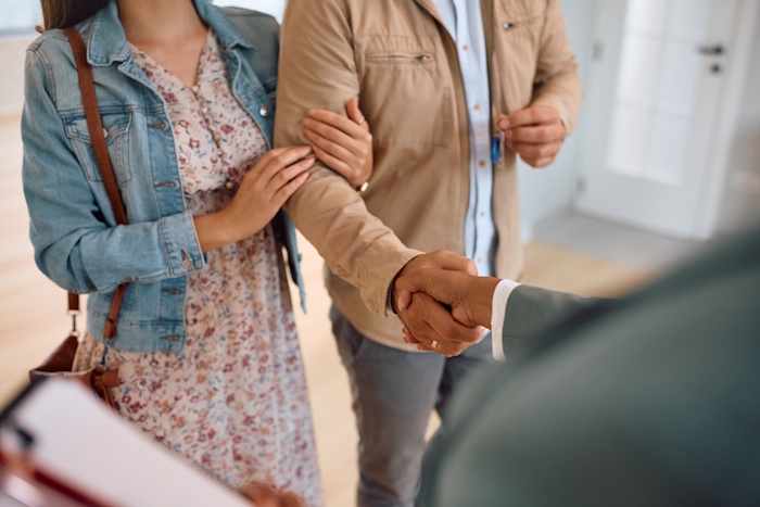 real estate agent shaking hands with a family